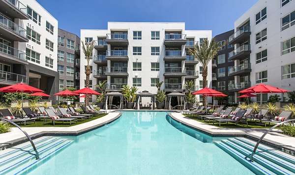 Relax by the sunny pool at Vora Mission Valley West Apartments, a luxurious Greystar community offering premium amenities in San Diego