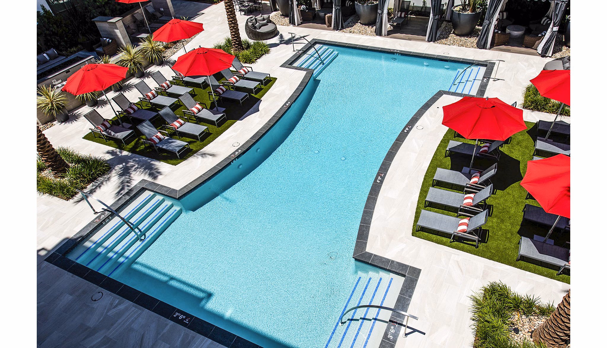 Resort-style pool with lounge seating at Vora Mission Valley West Apartments
