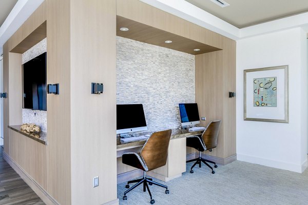 Clubhouse business center with modern workstations at Vora Mission Valley East Apartments, a luxurious Greystar community in San Diego