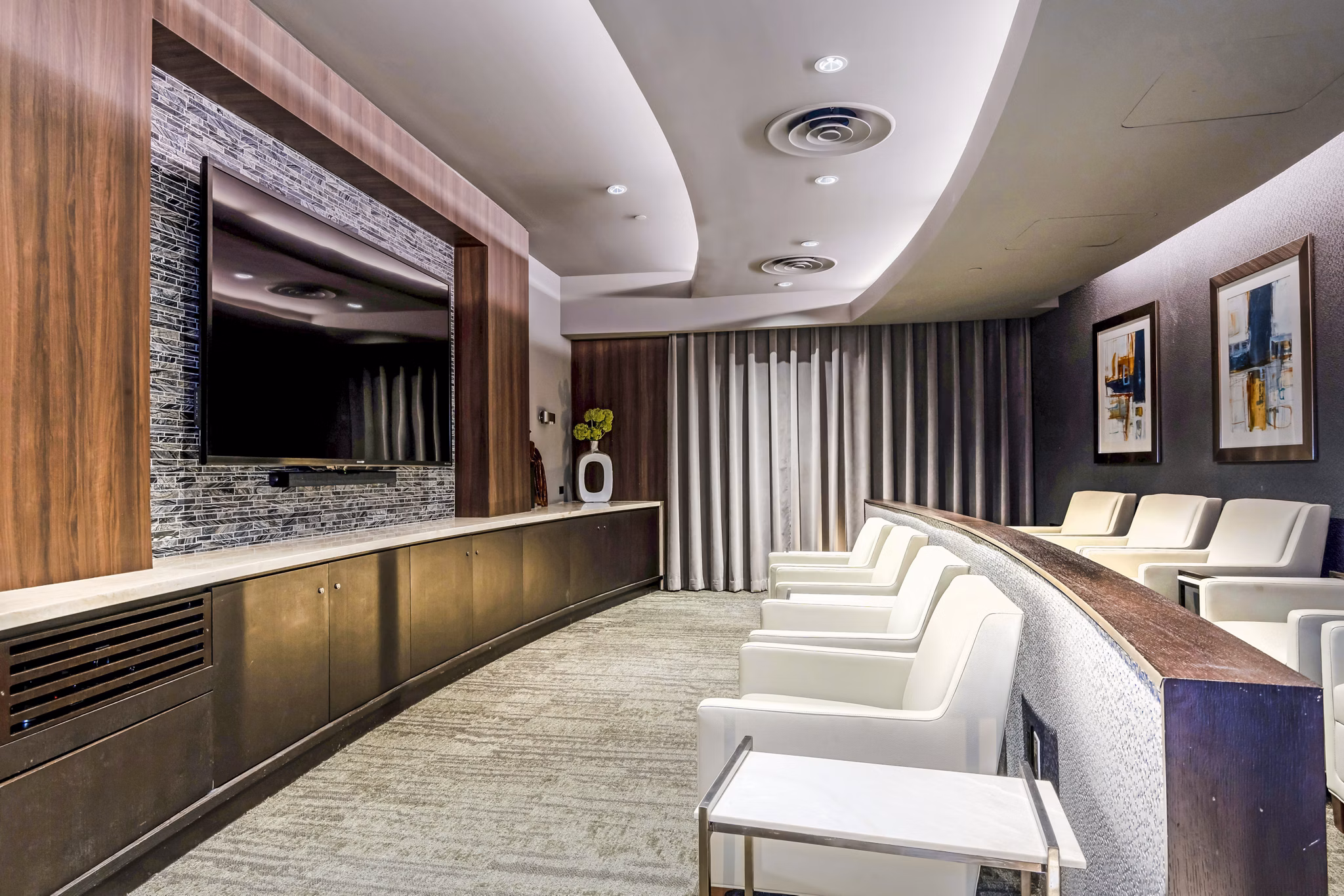 Clubhouse theater with plush seating and large screen at Vora Mission Valley East Apartments
