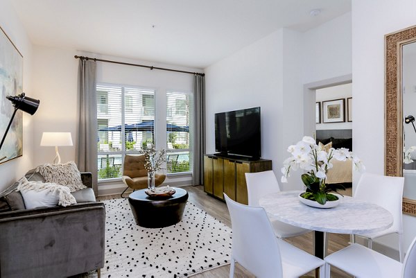 Modern dining room with elegant lighting and seating at Vora Mission Valley East Apartments in San Diego