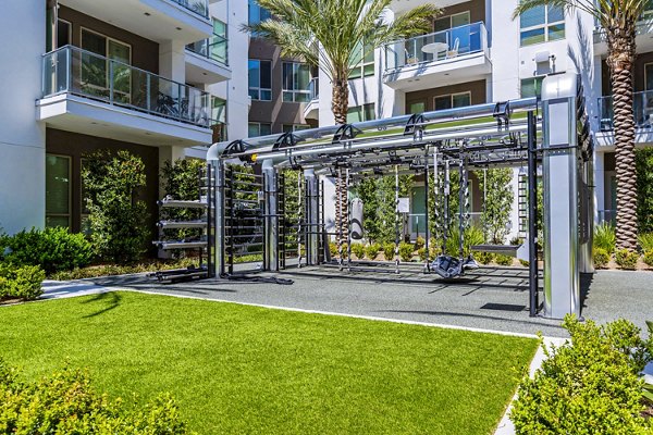 Outdoor fitness center featuring modern equipment at Vora Mission Valley East Apartments