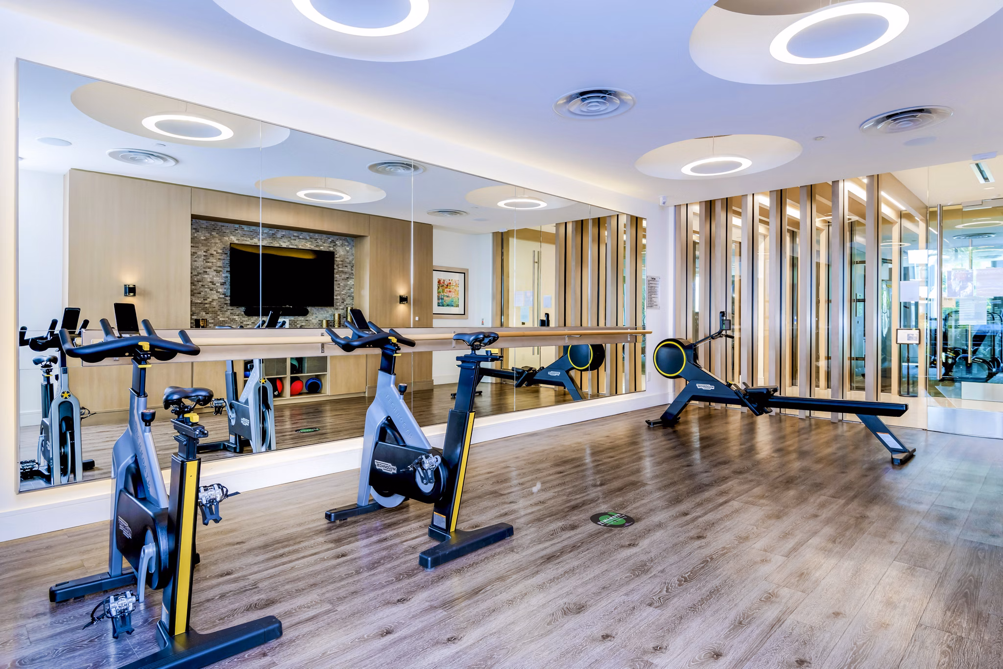 Spin studio with stationary bikes at Vora Mission Valley East Apartments, providing residents with a high-energy workout space