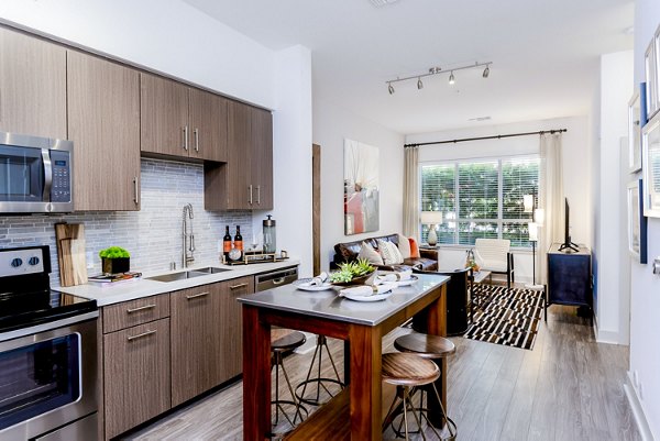 Kitchen featuring modern appliances and granite countertops in Vora Mission Valley East Apartments
