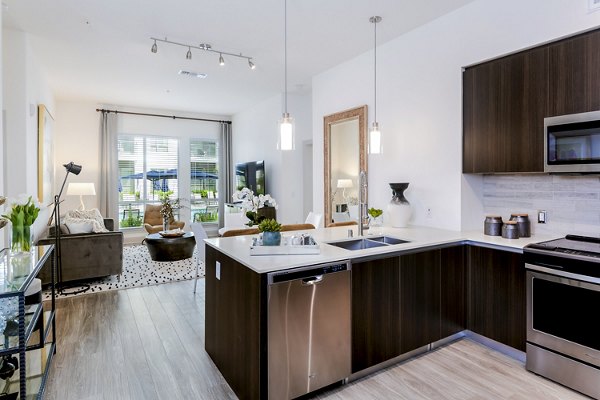 Modern kitchen with sleek countertops and stainless-steel appliances at Vora Mission Valley East Apartments