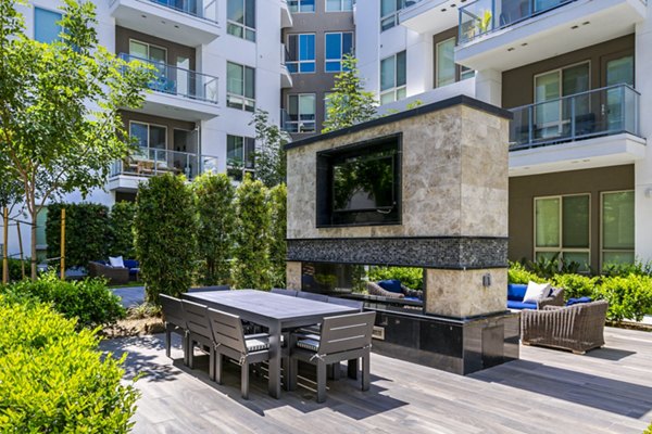 Vora Mission Valley East Apartments: Outdoor patio featuring modern seating and lush landscaping in a vibrant San Diego community