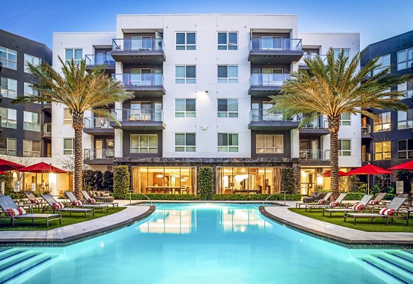 Resort-style pool at Vora Mission Valley East Apartments with lounge seating and landscaped surroundings for luxury living in San Diego