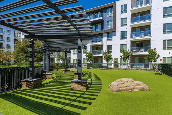 Vora Mission Valley East Apartments: Spacious dog park with agility equipment in San Diego community