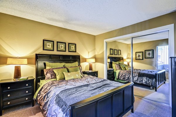 Luxurious bedroom featuring modern decor and king bed at Shadowridge Woodbend Apartments in a serene setting