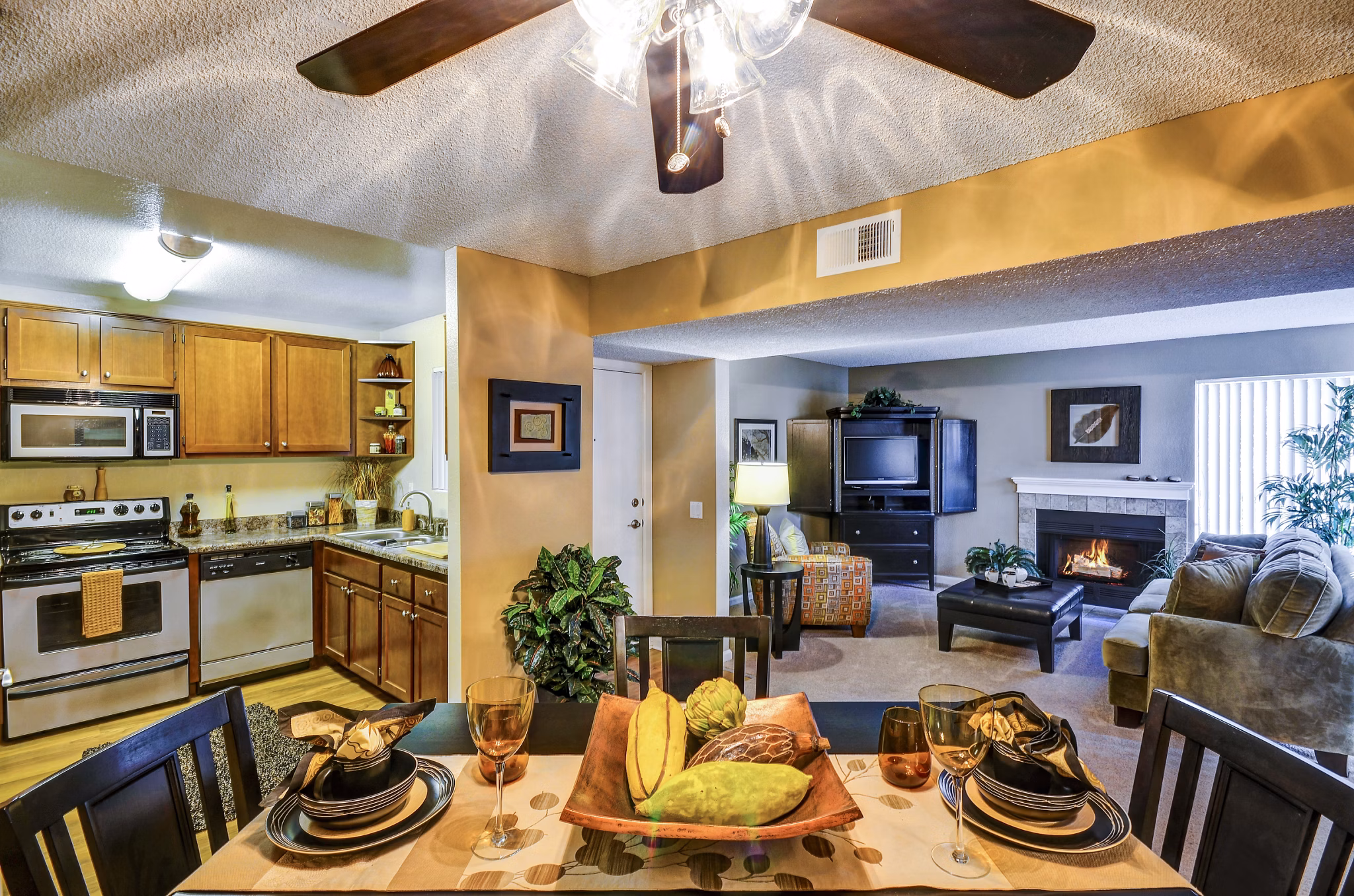 Dining room with elegant lighting and wooden dining set at Shadowridge Woodbend Apartments luxury community