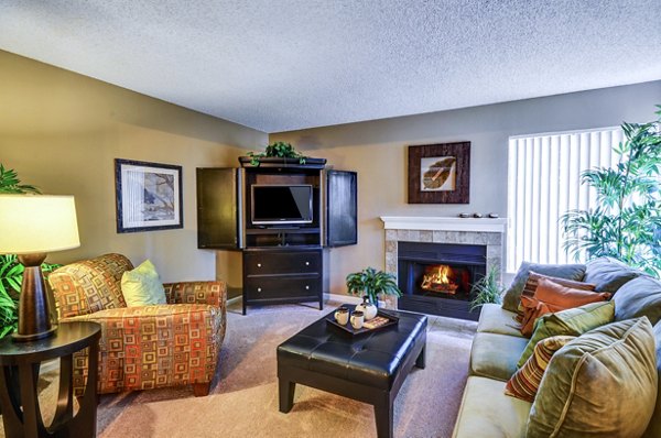 Inviting living room with cozy seating and natural light at Shadowridge Woodbend Apartments