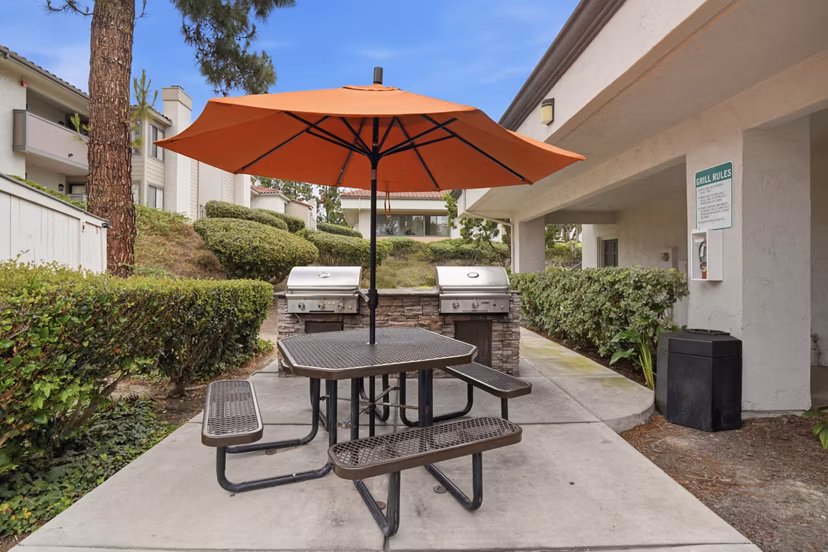 Cozy outdoor fire pit area at Shadowridge Woodbend Apartments with comfortable seating for gatherings in a tranquil setting