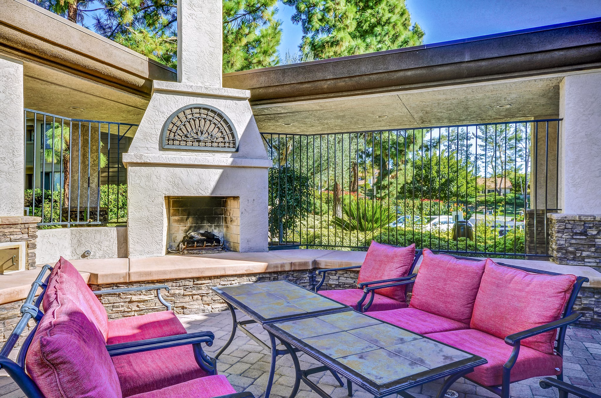 Cozy outdoor fire pit area at Shadowridge Woodbend Apartments with comfortable seating for gatherings in a tranquil setting