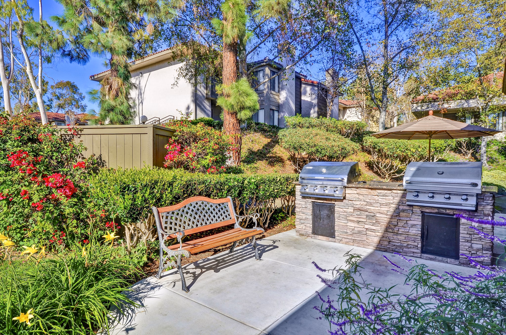 Outdoor grill area with modern seating at Shadowridge Woodbend Apartments, perfect for social gatherings in a luxury apartment community