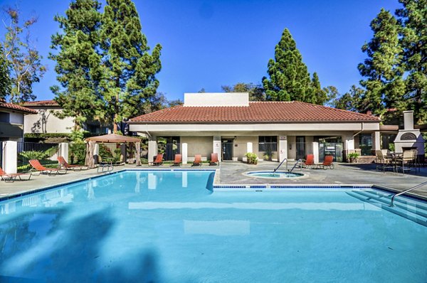 Peaceful outdoor pool at Shadowridge Woodbend Apartments with surrounding greenery