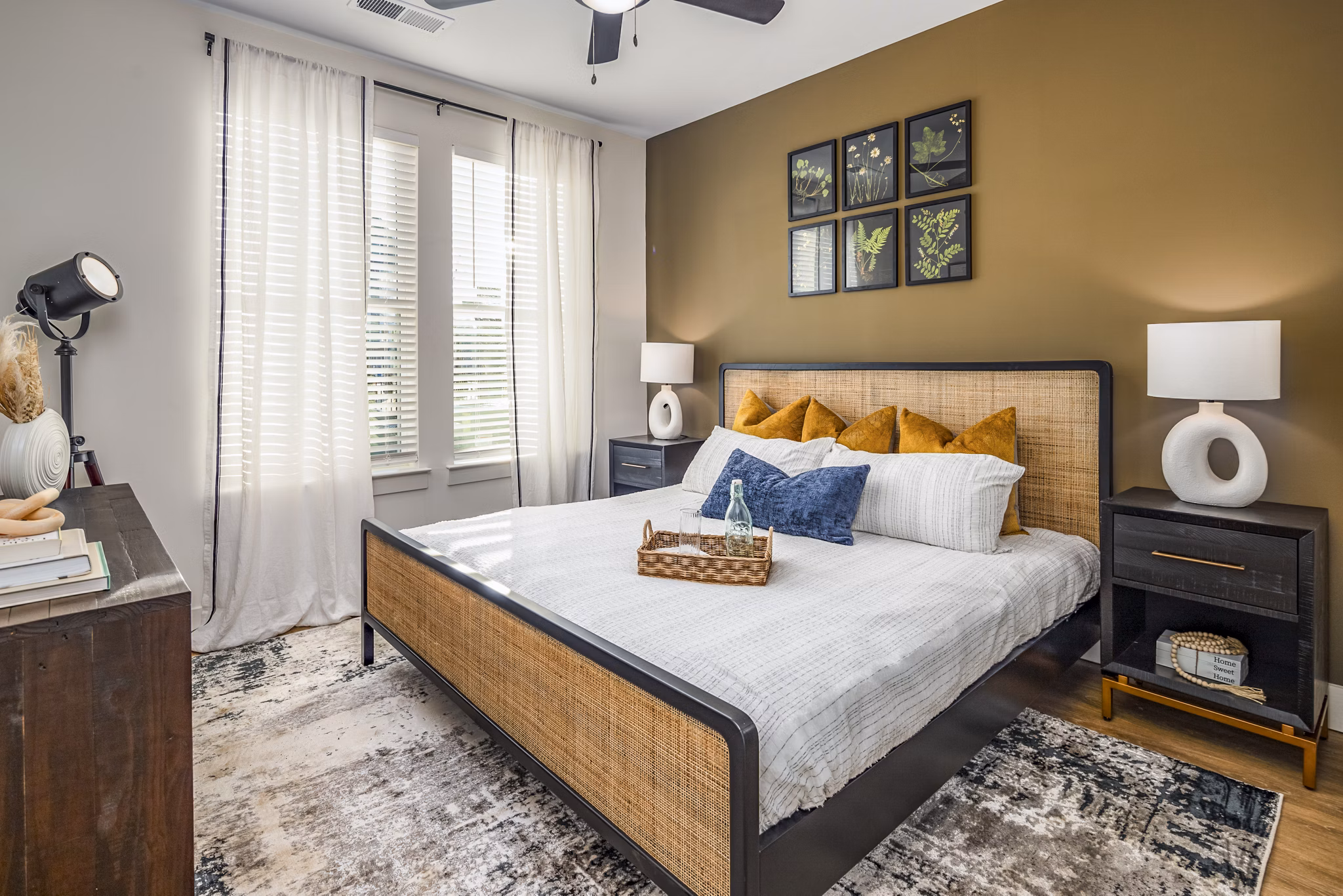 Bedroom featuring king bed and modern decor in NOVEL Harpeth Heights by Crescent Communities Apartments