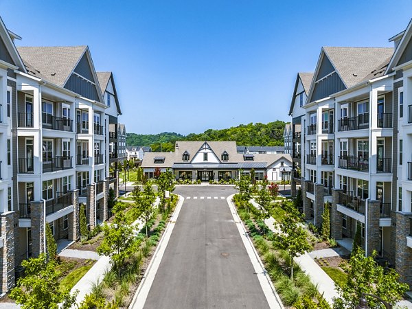 Outdoor swimming pool area with lounge chairs at luxury apartments