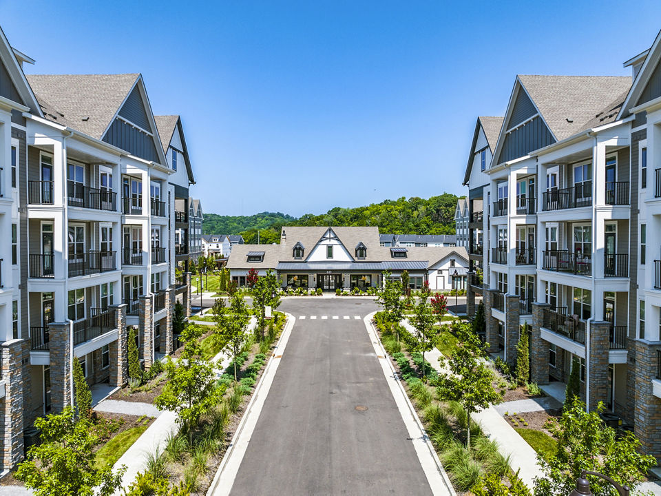 Outdoor swimming pool area with lounge chairs at luxury apartments