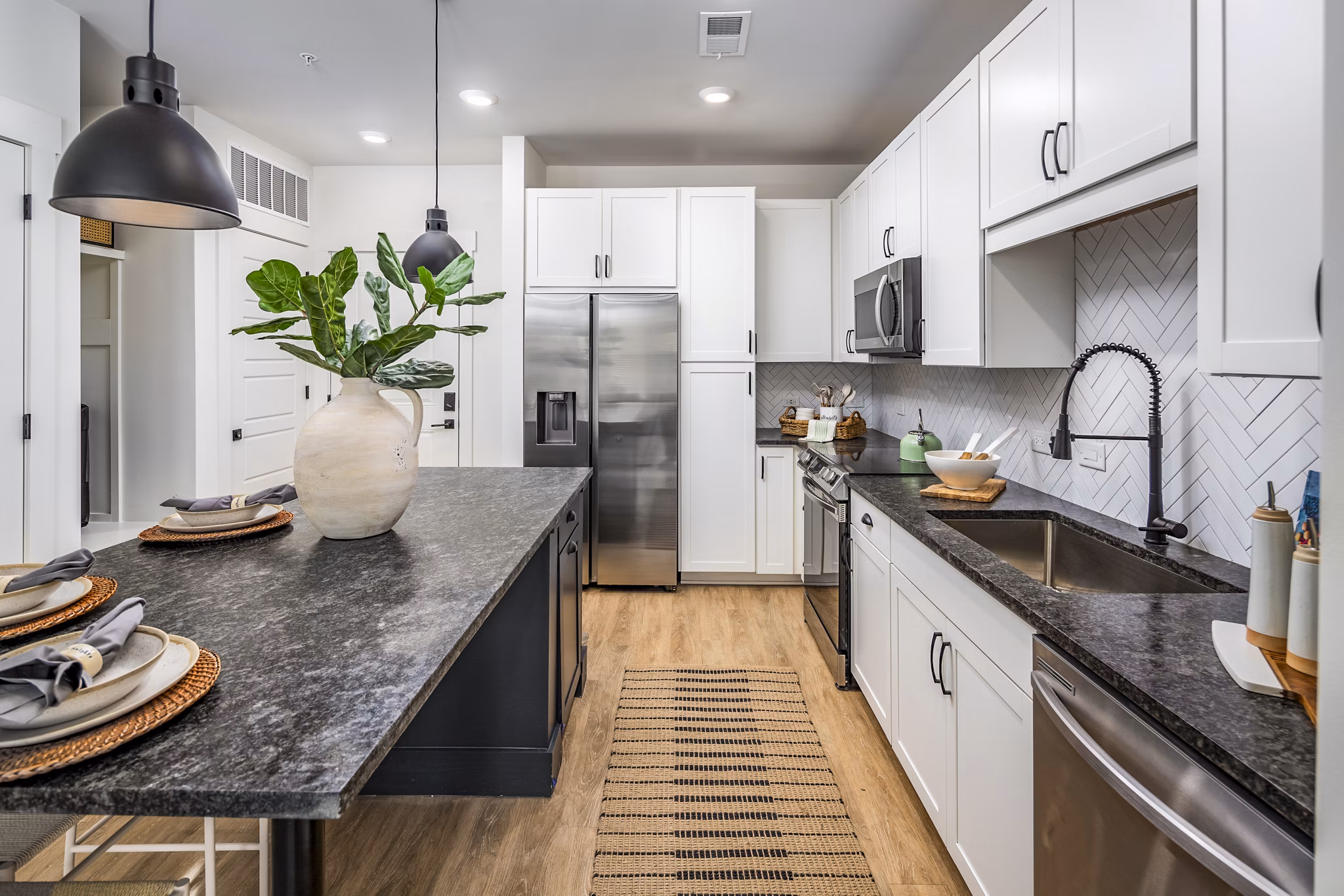 Modern kitchen with sleek countertops and stainless steel appliances at NOVEL Harpeth Heights by Crescent Communities Apartments