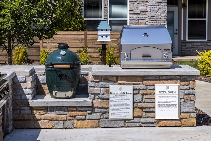 Outdoor grill area with modern seating at NOVEL Harpeth Heights by Crescent Communities Apartments
