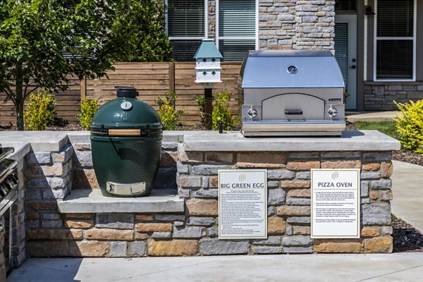 Outdoor grill area with modern seating at NOVEL Harpeth Heights by Crescent Communities Apartments