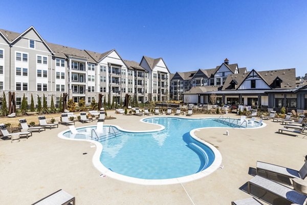 Outdoor pool with spacious sun deck at NOVEL Harpeth Heights Apartments by Crescent Communities