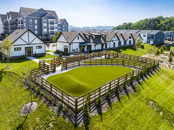 Residential neighborhood with landscaped lawns and fenced grassy areas near luxury apartments