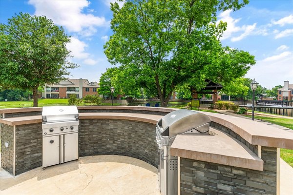 Patio space with comfortable seating and greenery at Ashford Apartments