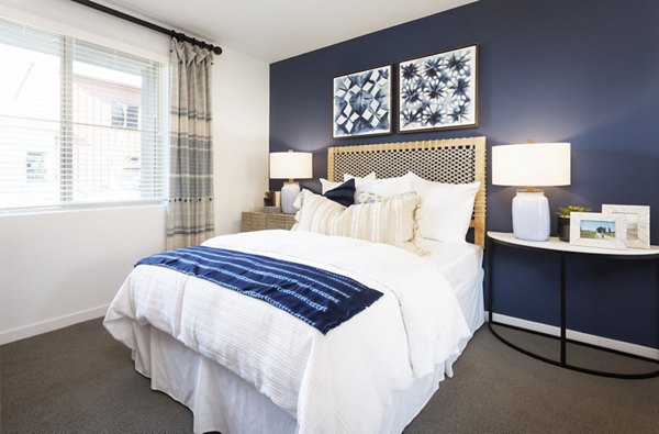Bedroom featuring modern decor and plush bedding at Kendry Apartments, the luxury community in the Greystar portfolio