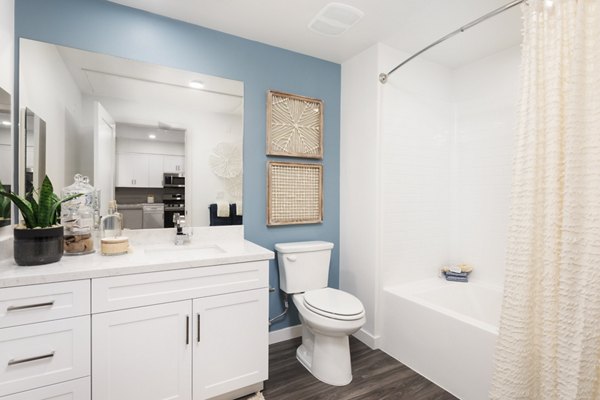 Bathroom featuring modern finishes and dual sinks at Kendry Apartments