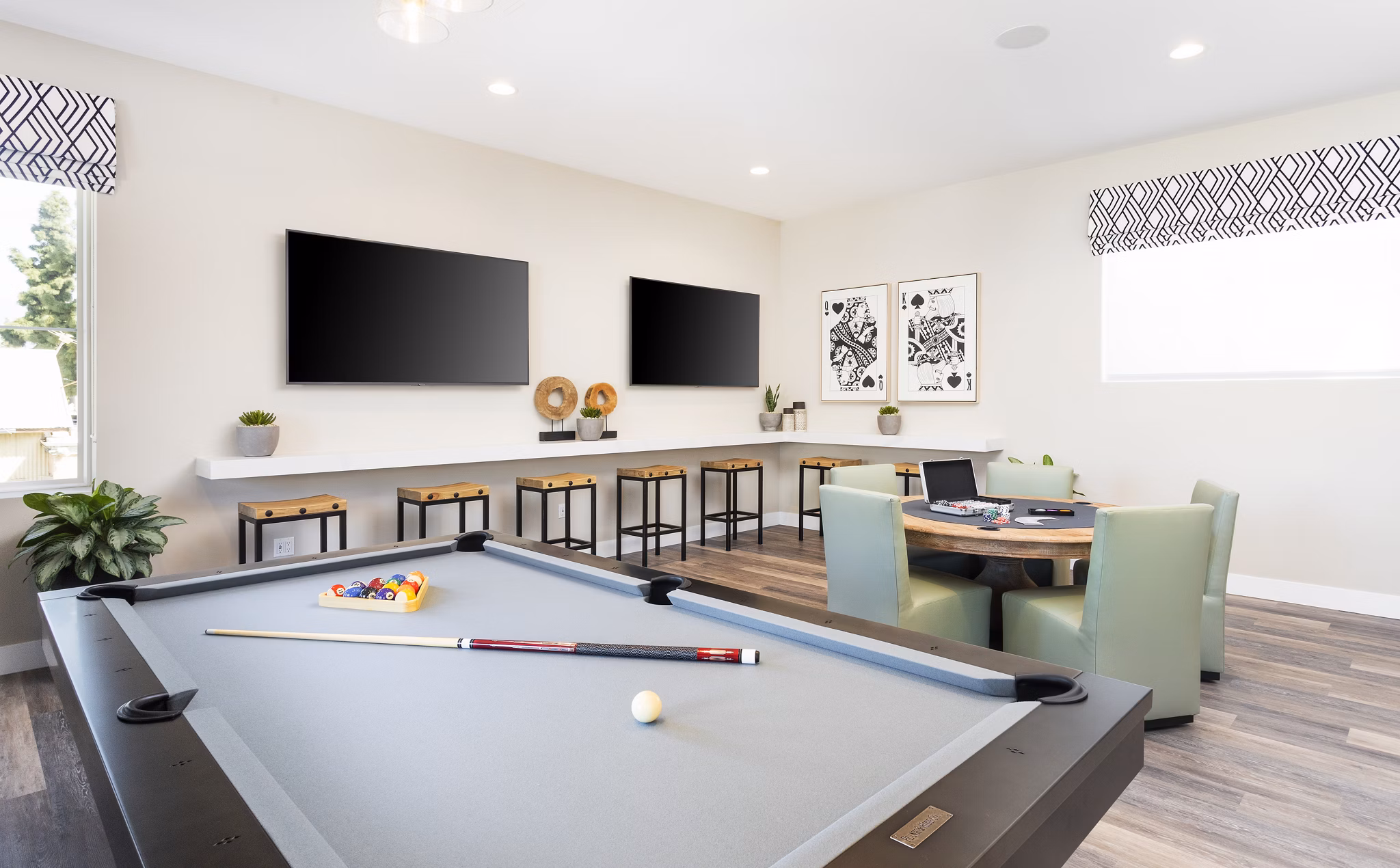 Billiards table and seating in the game room at Kendry Apartments, offering a fun leisure space in Greystar's luxury community