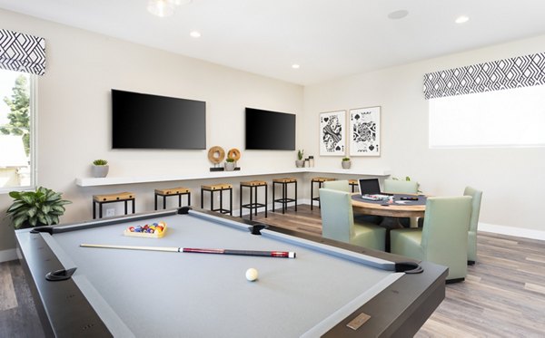 Billiards table and seating in the game room at Kendry Apartments, offering a fun leisure space in Greystar's luxury community