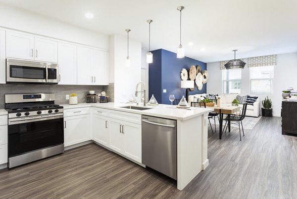 Modern kitchen with sleek cabinetry and stainless steel appliances in Kendry Apartments