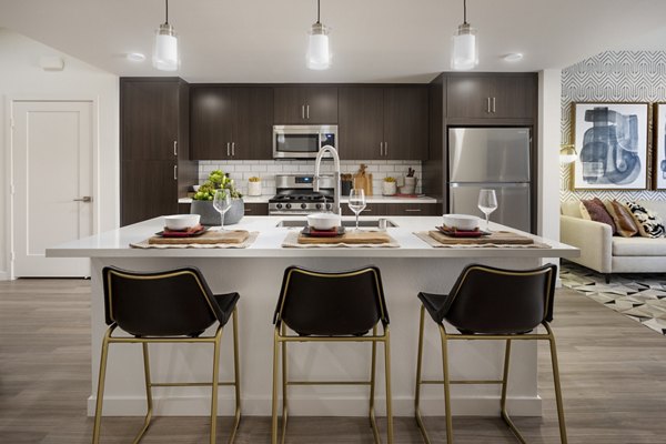 Kendry Apartments: Contemporary kitchen with sleek stainless steel appliances and granite countertops