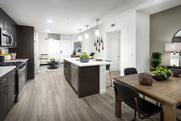 Elegant kitchen with stainless steel appliances and granite countertops at Kendry Apartments, a Greystar luxury property