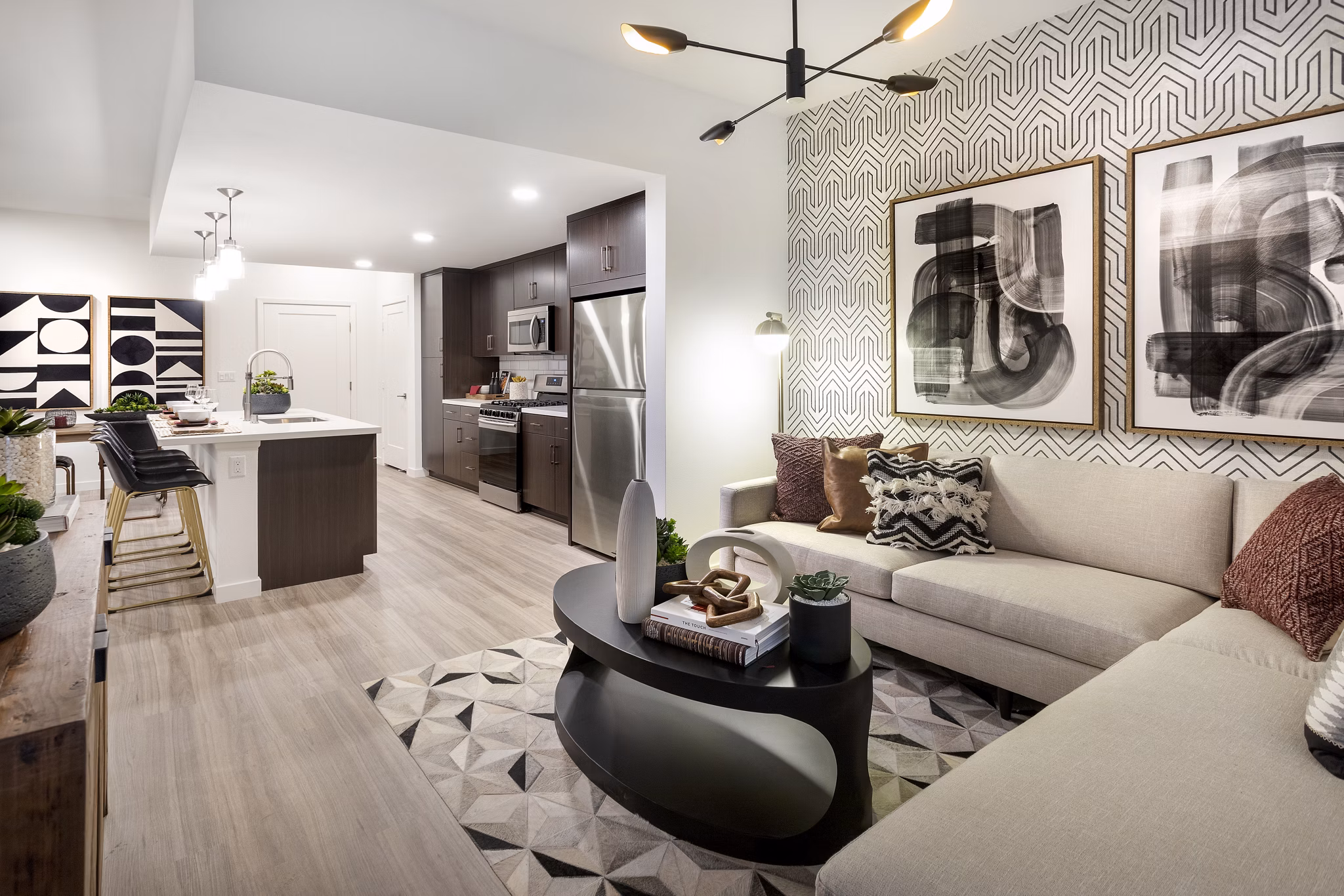 Spacious living room with modern decor and large windows at Kendry Apartments