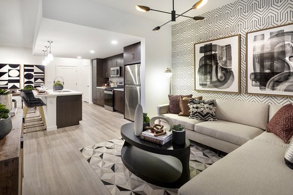 Spacious living room with modern decor and large windows at Kendry Apartments