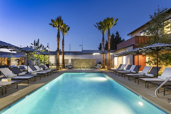 Kendry Apartments: Resort-style pool with cabanas and loungers, perfect for relaxation and leisure activities in luxury living environment