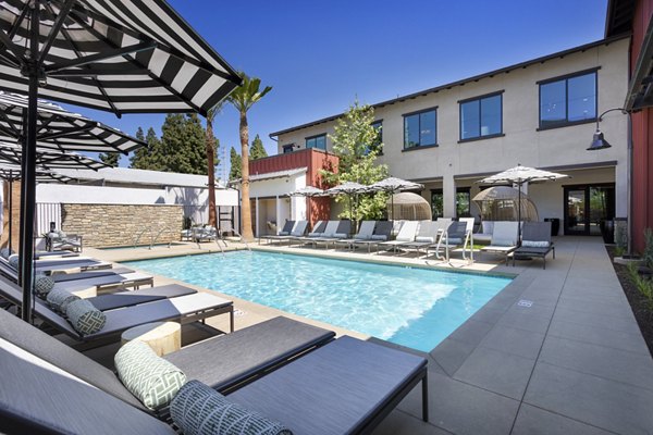 Resort-style pool with lounge chairs at Kendry Apartments
