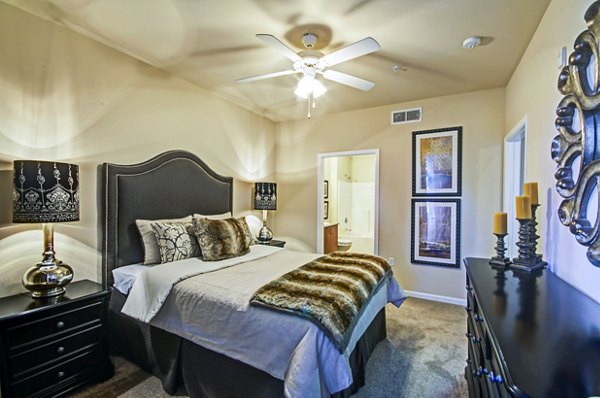 Cozy bedroom with large windows at Ridgestone Apartments