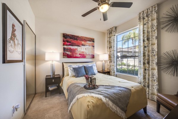 Cozy bedroom featuring plush bedding and stylish decor at Solana Ridge Apartments, a Greystar luxury apartment community