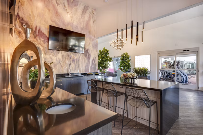 Modern clubhouse featuring expansive seating and a central fireplace at Solana Ridge Apartments, a Greystar luxury property