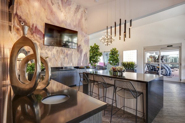 Modern clubhouse featuring expansive seating and a central fireplace at Solana Ridge Apartments, a Greystar luxury property