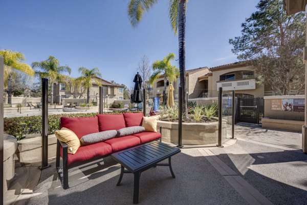 Inviting courtyard with lush landscaping and seating area at Solana Ridge Apartments, perfect for relaxation and community gatherings