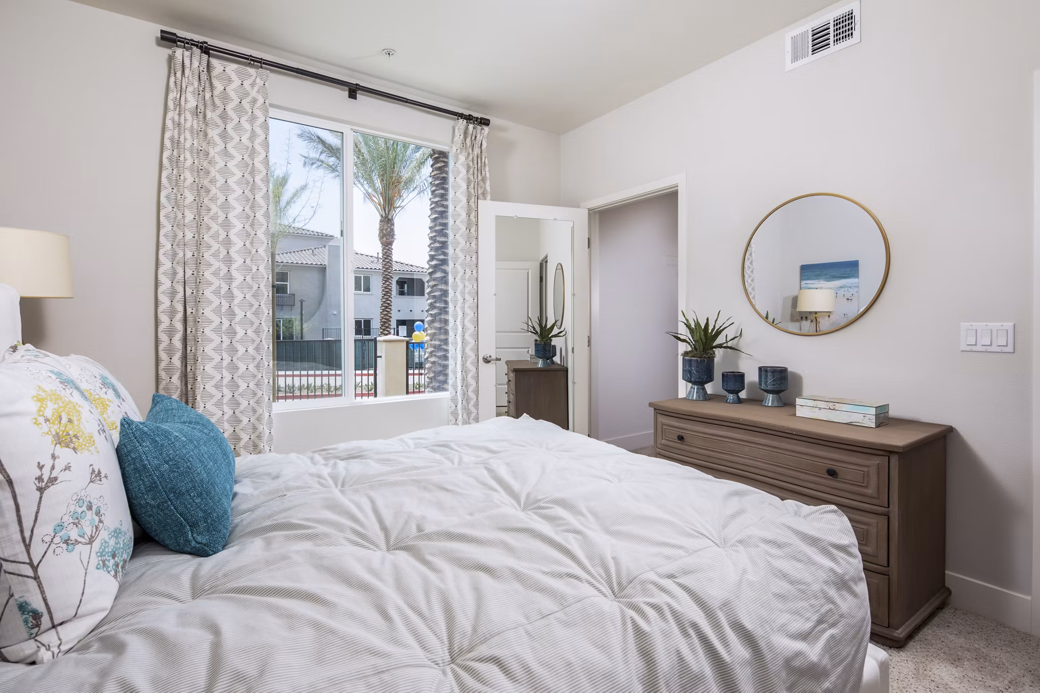 Bedroom with elegant decor and plush bedding at Sorano Apartments, a Greystar luxury apartment residence