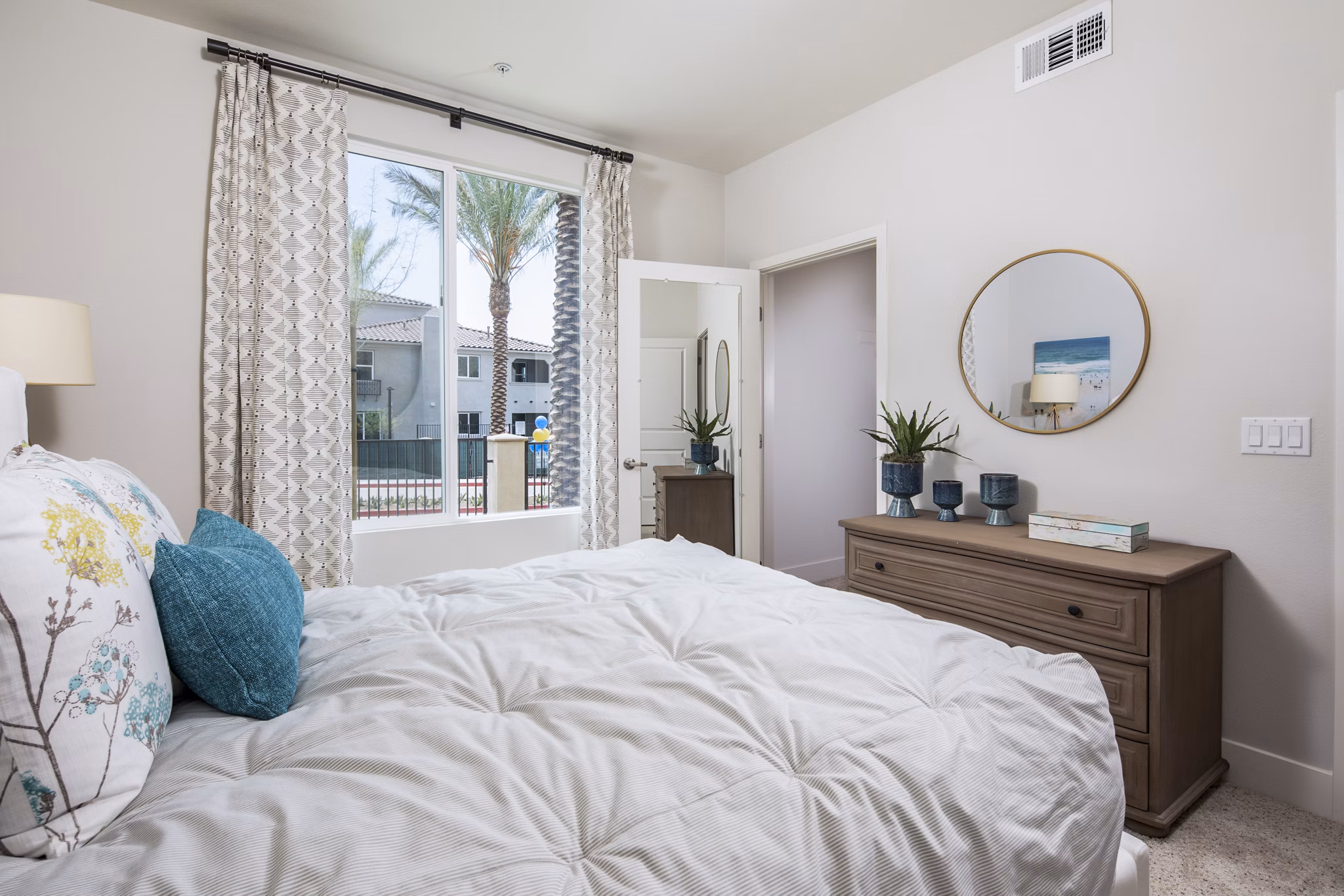 Bedroom with elegant decor and plush bedding at Sorano Apartments, a Greystar luxury apartment residence