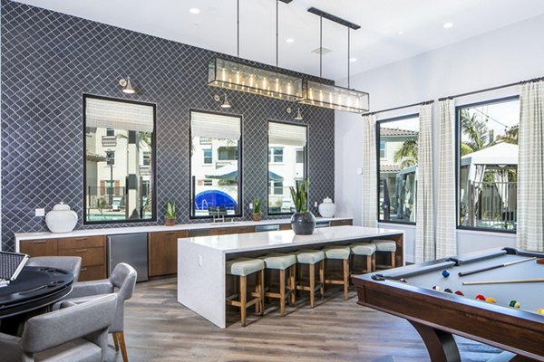 Sorano Apartments: Modern clubhouse kitchen with sleek countertops and stainless steel appliances