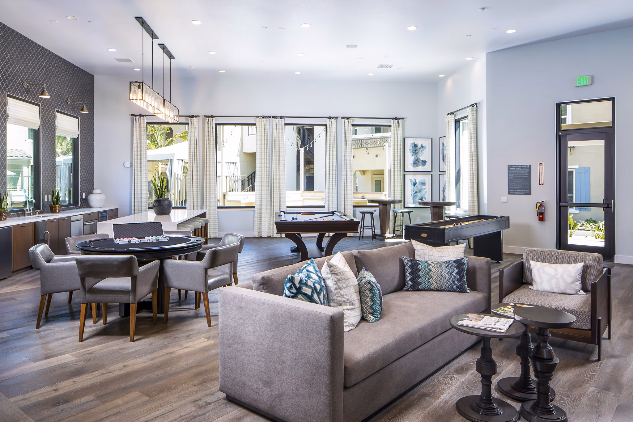 Clubhouse with billiards table and lounge seating at Sorano Apartments providing entertainment and relaxation options for residents
