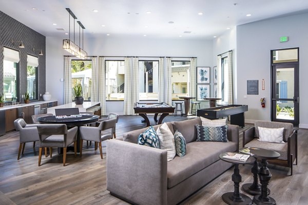 Clubhouse with billiards table and lounge seating at Sorano Apartments providing entertainment and relaxation options for residents