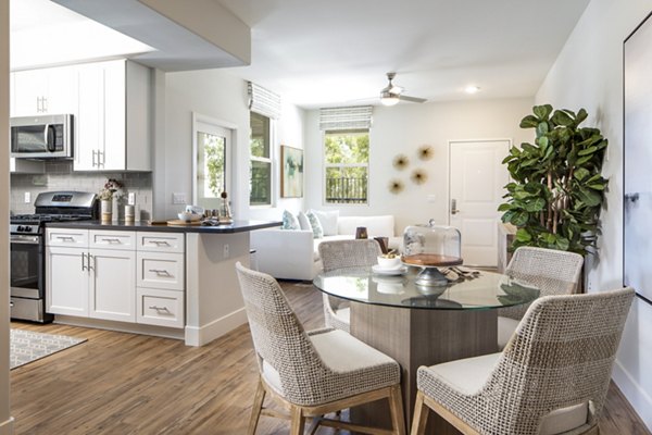 Dining room featuring elegant wood furniture and modern lighting at Sorano Apartments